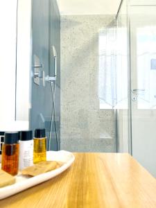 a wooden table with two bottles of essential oils on it at Piana Apartment in Carloforte +24 photos