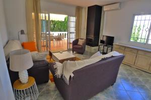 a living room with a couch and a table at Villa Golondrinas - Private villa to sleep 6 in Nerja
