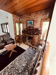 a living room with a couch and a fireplace at Rodeio das Lagoas in Cambara do Sul