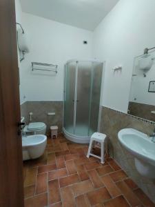 a bathroom with two sinks and a shower and a toilet at Guarda che Luna Apartment in Porto Empedocle