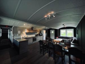 a kitchen and living room with a table and chairs at Gullingen Turistsenter in Gullingen