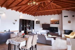 a living room with a table and a couch at Villa Ftelia Oasis,Skiathos in Megali Ammos