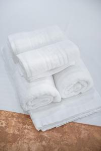 a stack of white towels sitting on top of a table at Vila Puky in Neptun +253 photos