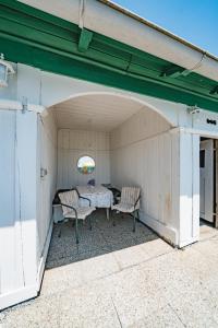 a patio with a table and two chairs at Villa Fernblick in Velden am Wörthersee