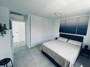 a bedroom with a white bed and a large window at Villa Nikki-Adore in Mazarrón +43 photos