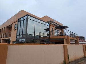 a building with glass windows on top of it at Jate Guest House in Maseru