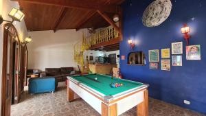 a living room with a pool table in it at Hostel Na Praia - Hospedagens e eventos in Ubatuba