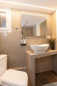 a bathroom with a sink and a mirror at Houseloft Metropolitan Highlight in Thessaloniki