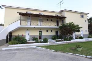 a house with a balcony on top of it at Yiannis Studios in Troulos