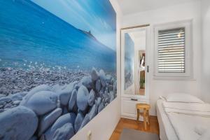 a bedroom with a mural of birds on the wall at Sunrise Apartment Hvar in Hvar