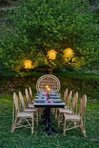 a table with chairs around it with a candle on it at Minimalist : An Eco Farmstay in Nāldera