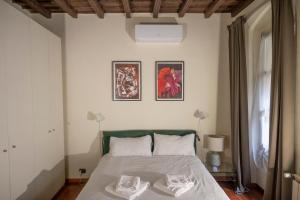 a bedroom with a bed and two pictures on the wall at Inappartamento Diamante in Turin