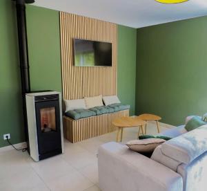 a living room with a couch and a fireplace at Gite : La maison d'Apolline in Tréhorenteuc