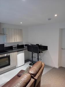 a living room with a couch in a kitchen at Windies apartment 1 in Bridlington