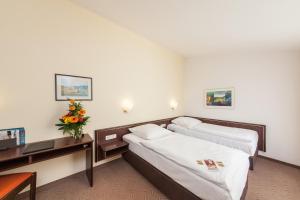 Postel nebo postele na pokoji v ubytování Hotel Strijewski