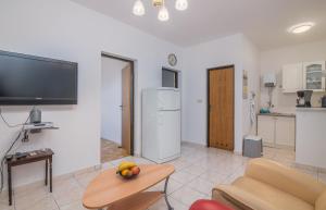 a living room with a couch and a table at Apartment Dinka in Čižići +18 photos