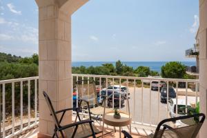 a balcony with chairs and a view of a parking lot at Sunrise Apartment Hvar in Hvar