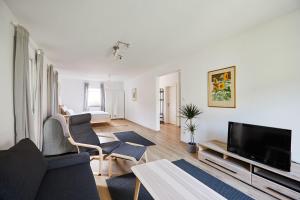 a living room with a couch and a tv at Ferienwohnung zum Steingarten in Krün