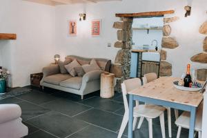 a living room with a couch and a table at Cute and cosy 2 bed cottage in beautiful Solva in Solva