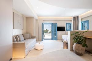 a living room with a couch and a table at Aura Suites Paros in Naousa