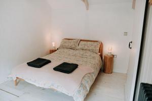a bedroom with a bed with two candles on it at Cute and cosy 2 bed cottage in beautiful Solva in Solva