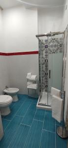 a bathroom with a shower and a toilet at Hotel Ortigia Royal Suite in Syracuse