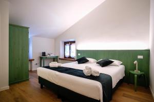 a bedroom with a large bed with towels on it at Locanda Il Cavallino in Valeggio sul Mincio