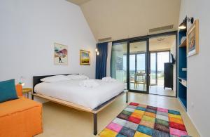 a bedroom with a bed and a colorful rug at Petrantica Resort in Marina di Ragusa