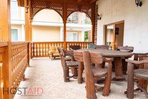 an outdoor patio with a wooden table and chairs at VILLA57 - Balatonalmádi - hostAID in Balatonalmádi