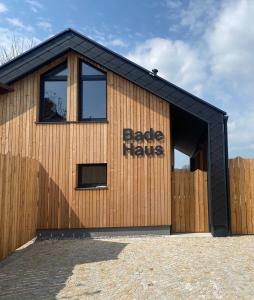 a building with a black roof with the words bare hands written on it at Gästehaus Leimer Bräu in Lenzing