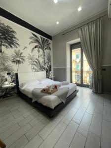 a bedroom with a bed with a table on it at Parthenope Rooms in Naples