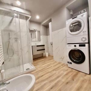 a bathroom with a washing machine and a washer at Casa Sobit in Turin