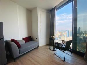 a living room with a couch and a large window at Edge Central Pattaya Vip Condo in Pattaya Central