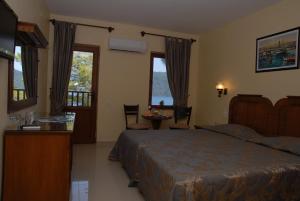 a bedroom with a bed and a table and chairs at Marmaris Park Hotel in Marmaris