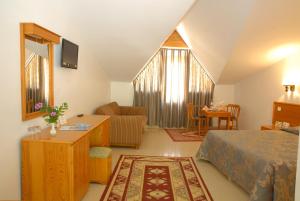 a bedroom with a bed and a living room at Marmaris Park Hotel in Marmaris