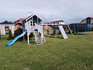 a playground with a slide at Domki Family Rowy in Rowy