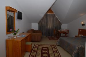 a hotel room with a bed and a living room at Marmaris Park Hotel in Marmaris