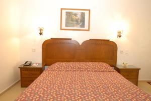 a bedroom with a bed and two night stands at Marmaris Park Hotel in Marmaris