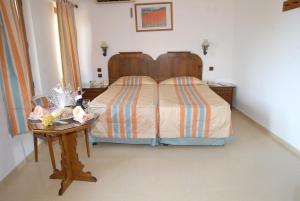 a bedroom with a bed and a table with a night stand at Marmaris Park Hotel in Marmaris