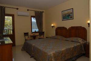 a bedroom with a bed and a table and chairs at Marmaris Park Hotel in Marmaris