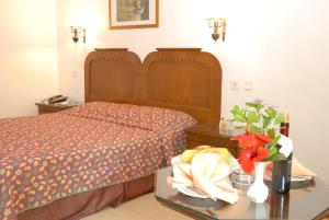 a hotel room with a bed and flowers on a table at Marmaris Park Hotel in Marmaris