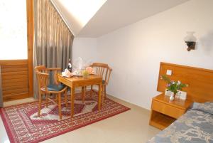 a room with a table and two chairs and a bed at Marmaris Park Hotel in Marmaris