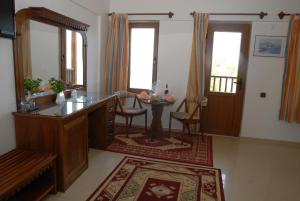 a living room with a table and a mirror at Marmaris Park Hotel in Marmaris