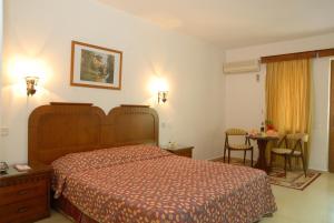 a hotel room with a bed and a table at Marmaris Park Hotel in Marmaris