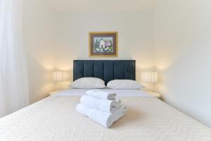 a bedroom with a bed with towels on it at Holiday Home Greystone in Omiš