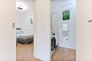 a bathroom with a washing machine in a room at Holiday Home Greystone in Omiš