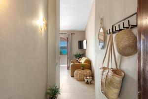 a hallway of a home with a living room at Baia Dorata beach apartments in Porto Istana