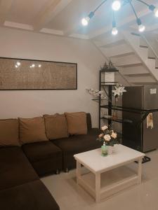 a living room with a couch and a coffee table at The Doll House 2.0 in Abucay