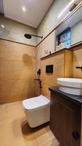 a bathroom with a toilet and a sink at Aaranya - A Boutique Stay in Bhopal