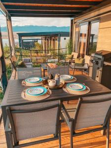 a wooden table with plates on it on a patio at SEAYA mobile home - Terra Park SpiritoS in Kolan +38 photos